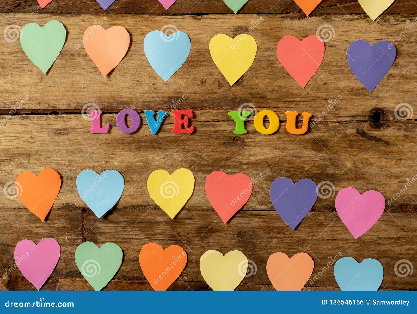 Multicolor Hearts On Wood Background And Text Love You For