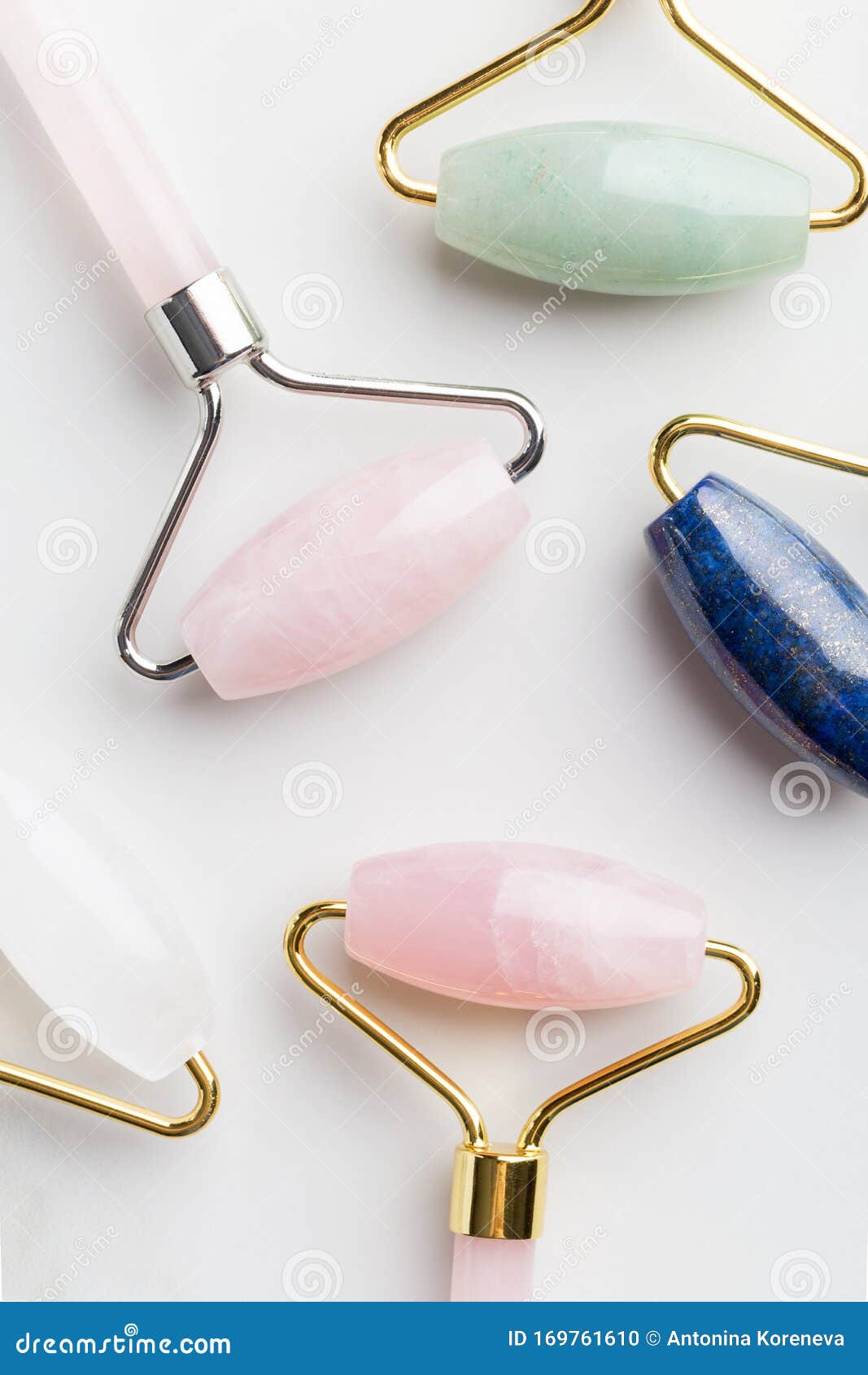 Multicolored Face Massage Rollers on White Background Stock Photo