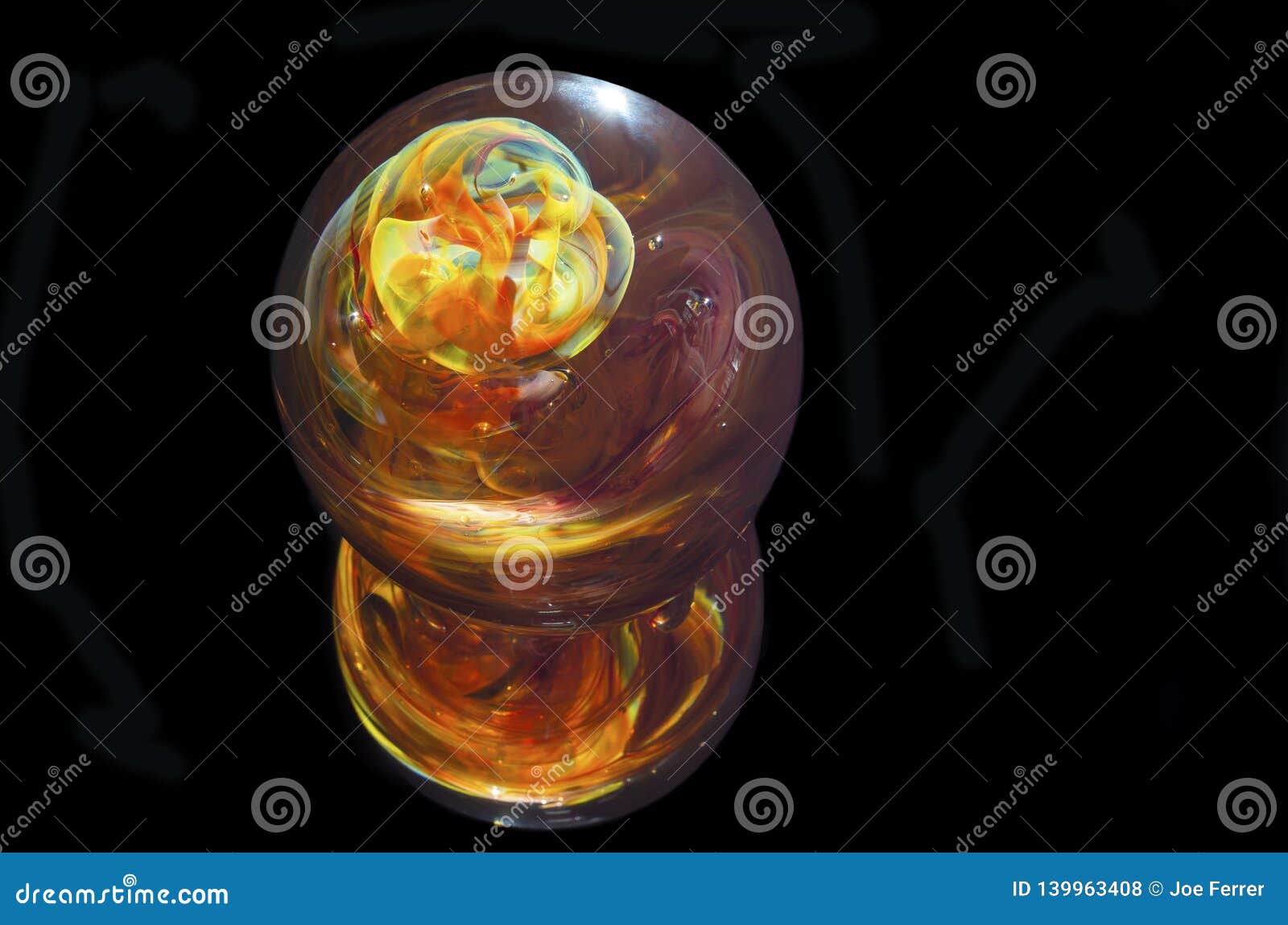 multicolored glass paperweight against black