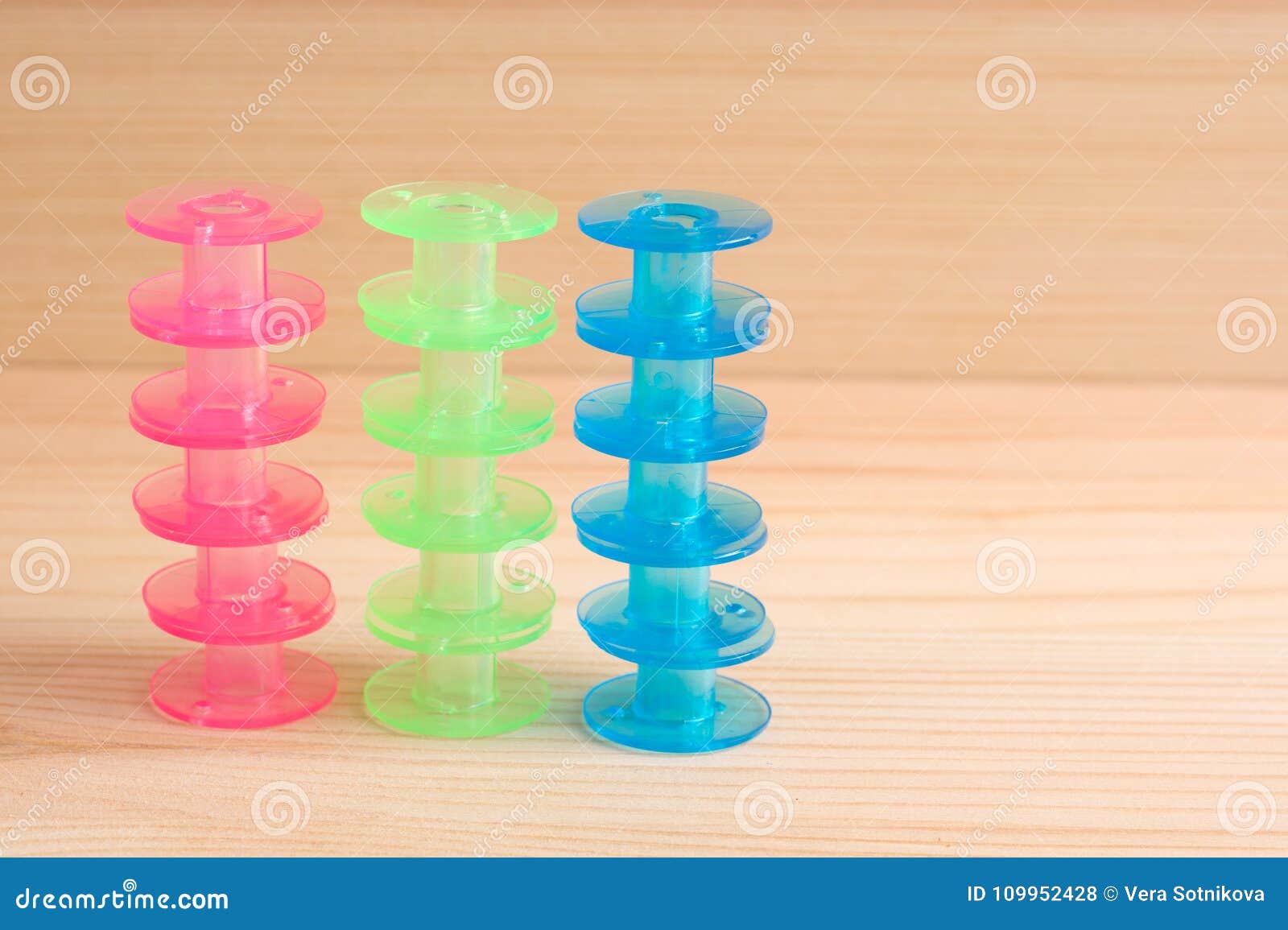 Multicolored Plastic Bobbin for Sewing Machine Layed in Rows in Stock