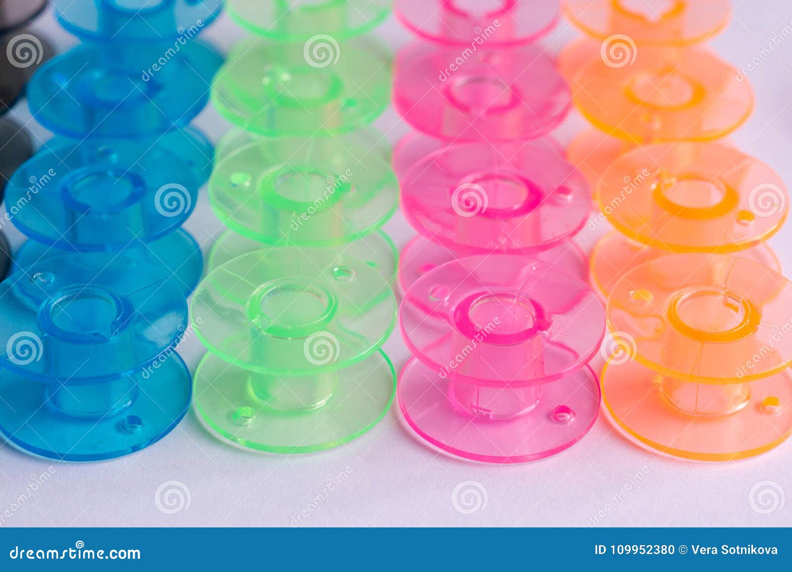 Multicolored Plastic Bobbin for Sewing Machine Layed in Rows in Stock