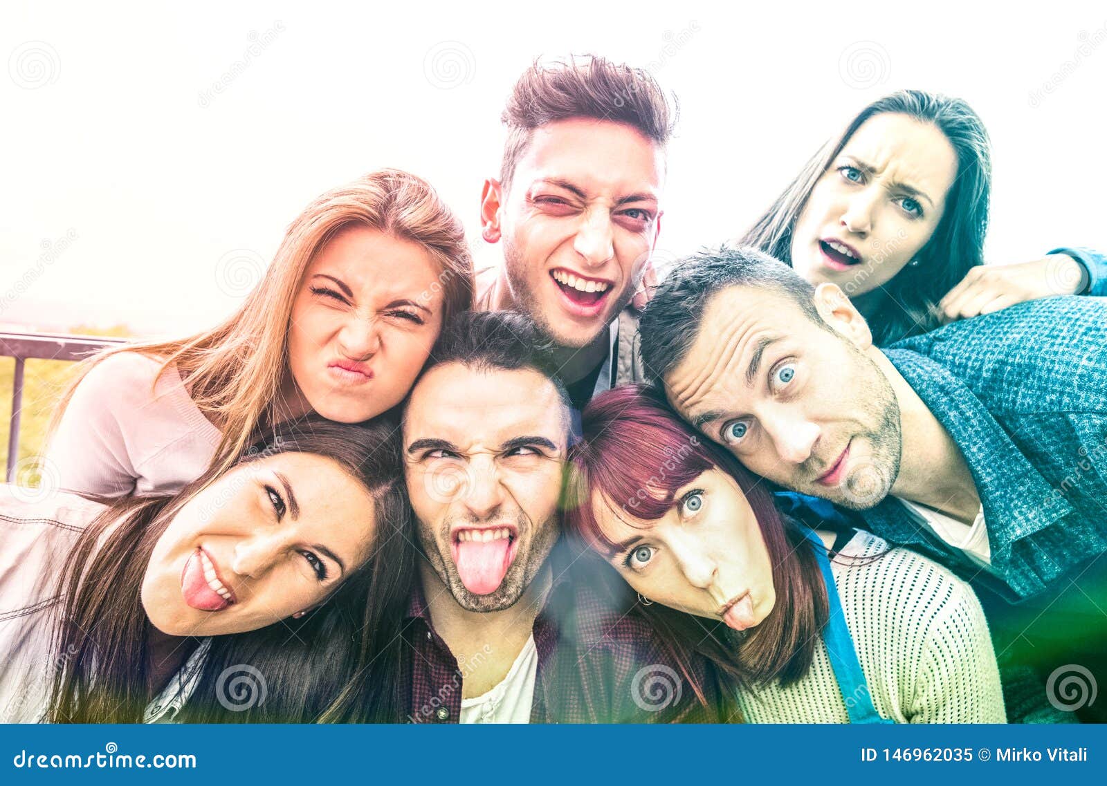 multicultural millenial friends taking selfie with funny faces - happy youth friendship concept with millennial young trends