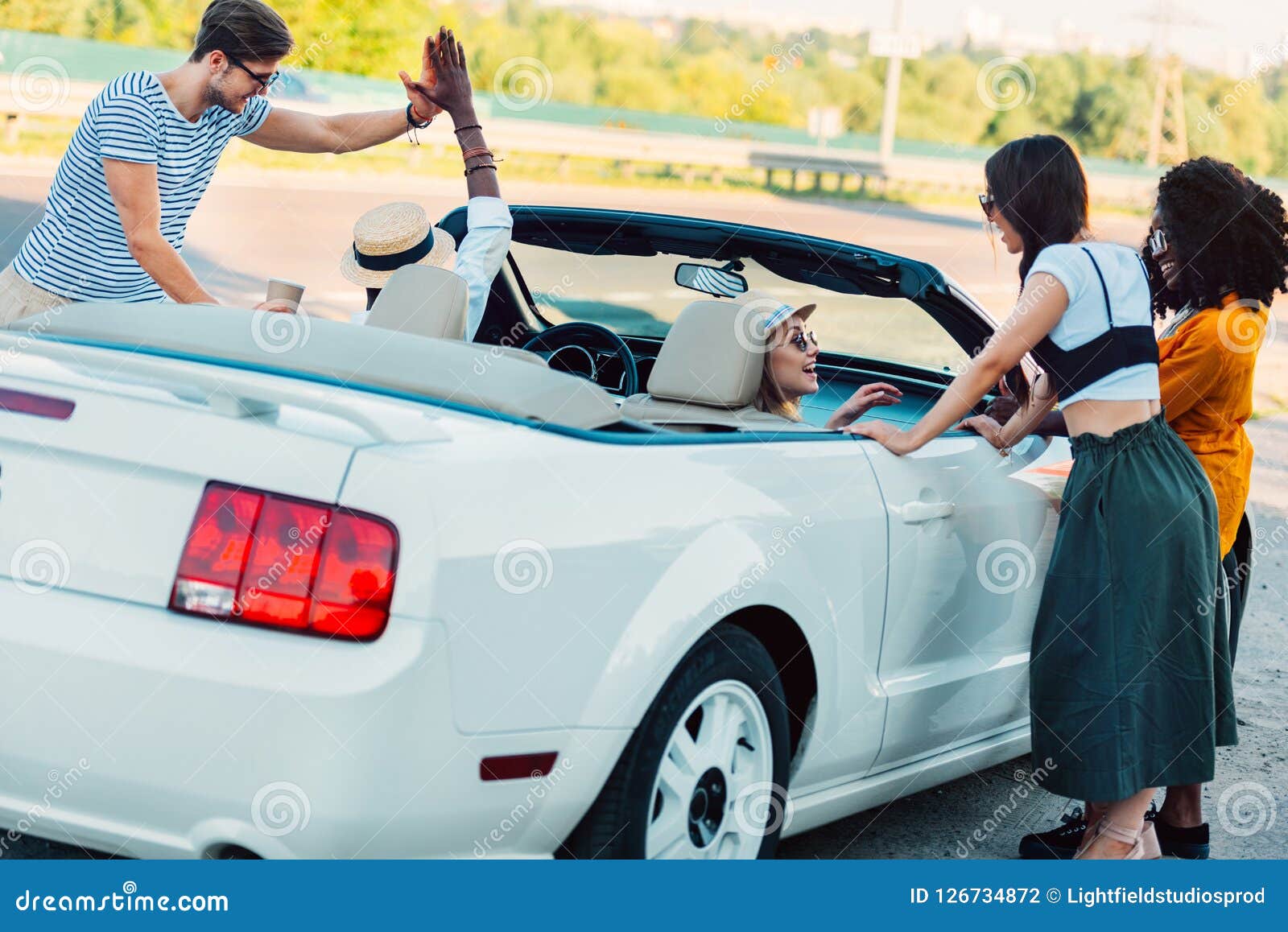 multicultural young men giving high five to each other while