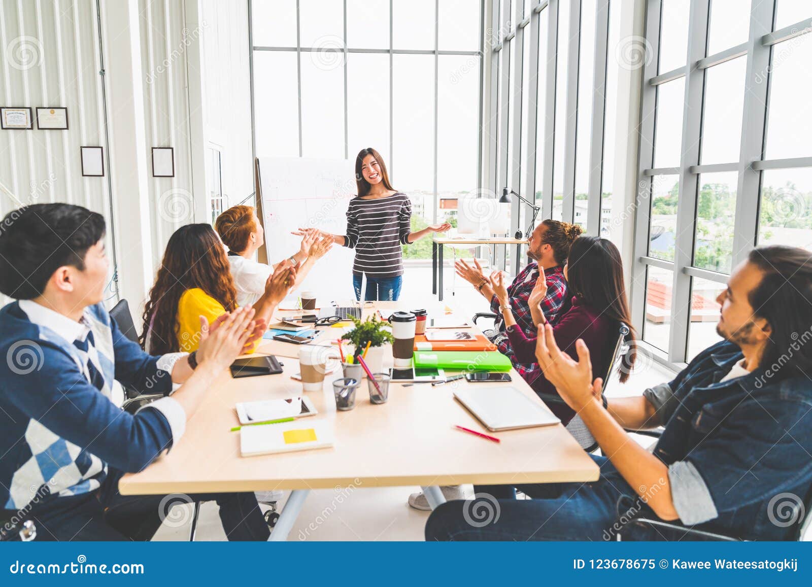 multiethnic diverse group of creative team or business coworker clap hands in project presentation meeting leading by asian woman