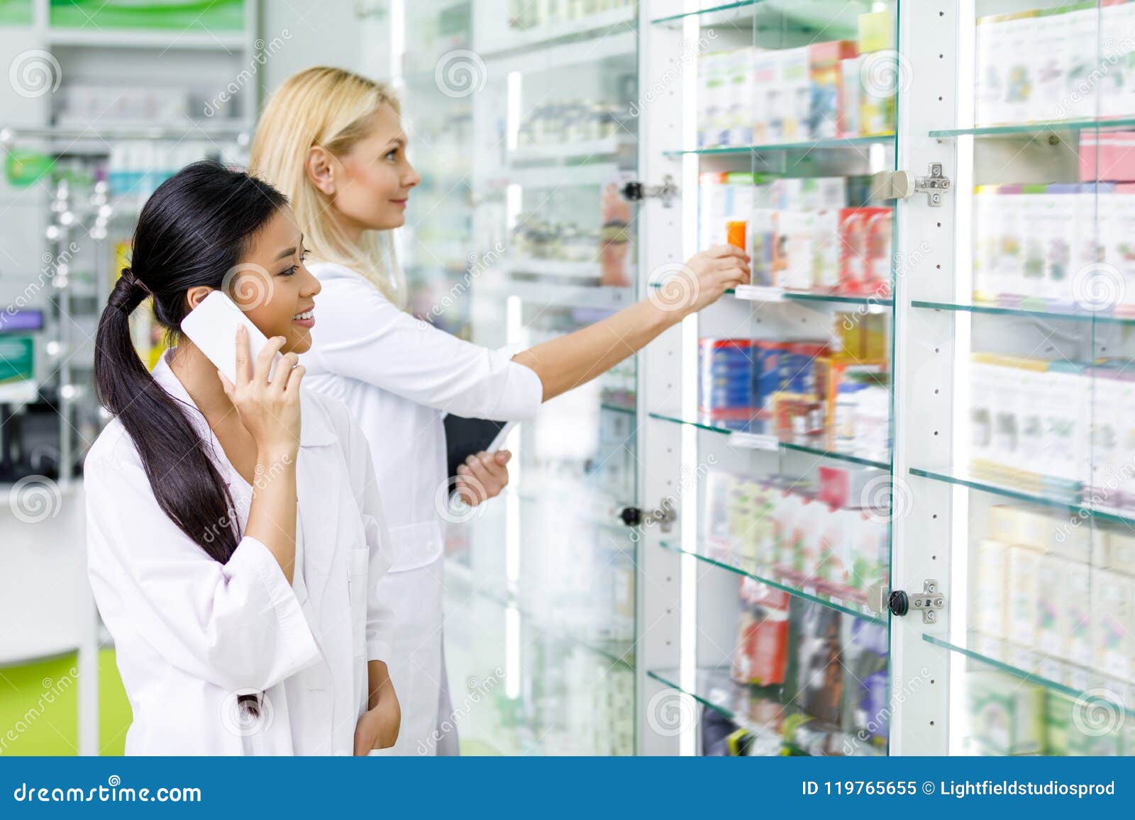 Multiethnic Female Pharmacists Using Digital Devices while Working Stock Image Image of copy