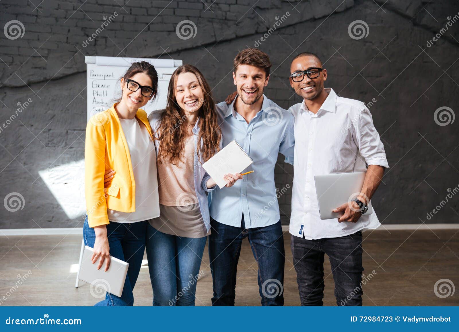 multiethnic group of happy young business people standing in office