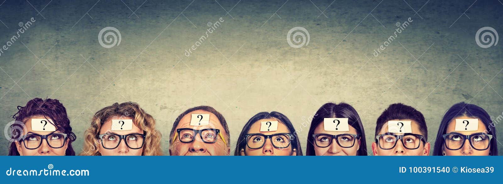 multiethnic group of thinking people in glasses with question mark looking up