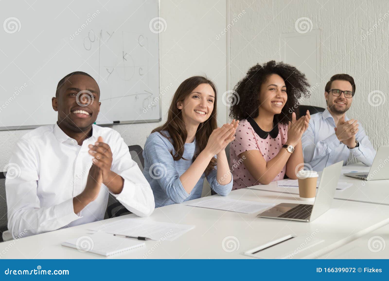 smiling diverse employees applaud thanking speaker for presentation