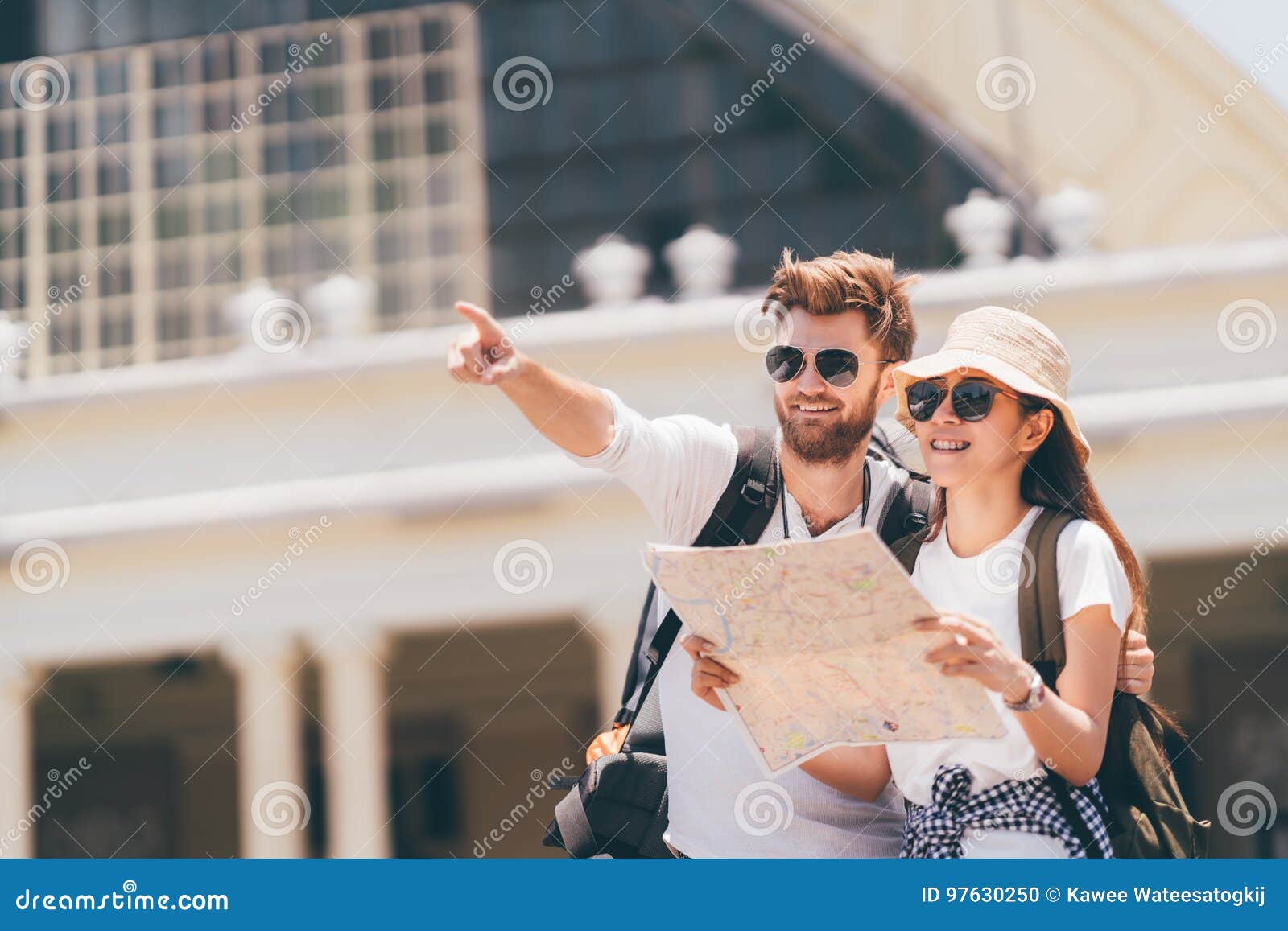multiethnic traveler couple using generic local map together on sunny day. honeymoon trip, backpacker tourist, asia tourism