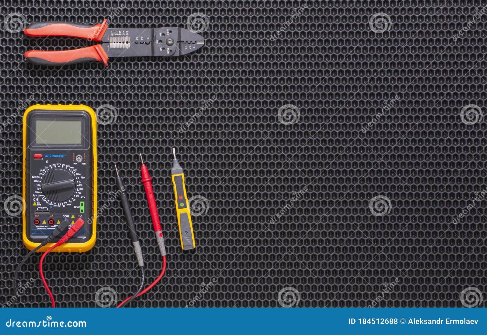 Multimeter, Indicator Screwdriver and Wire Stripper on a Black Rubber