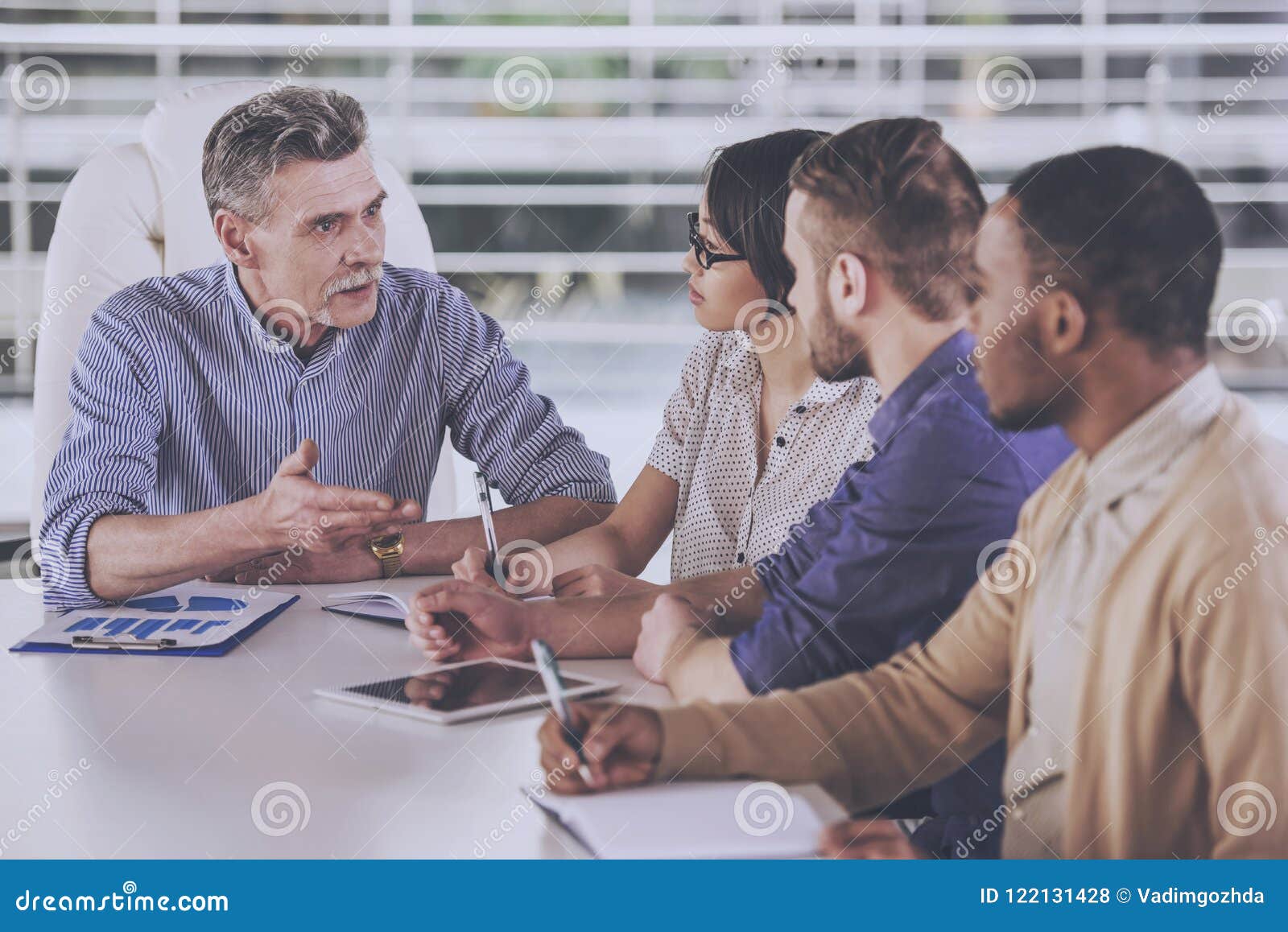 Multinational Group of People Discuss in Office. Stock Photo Image of