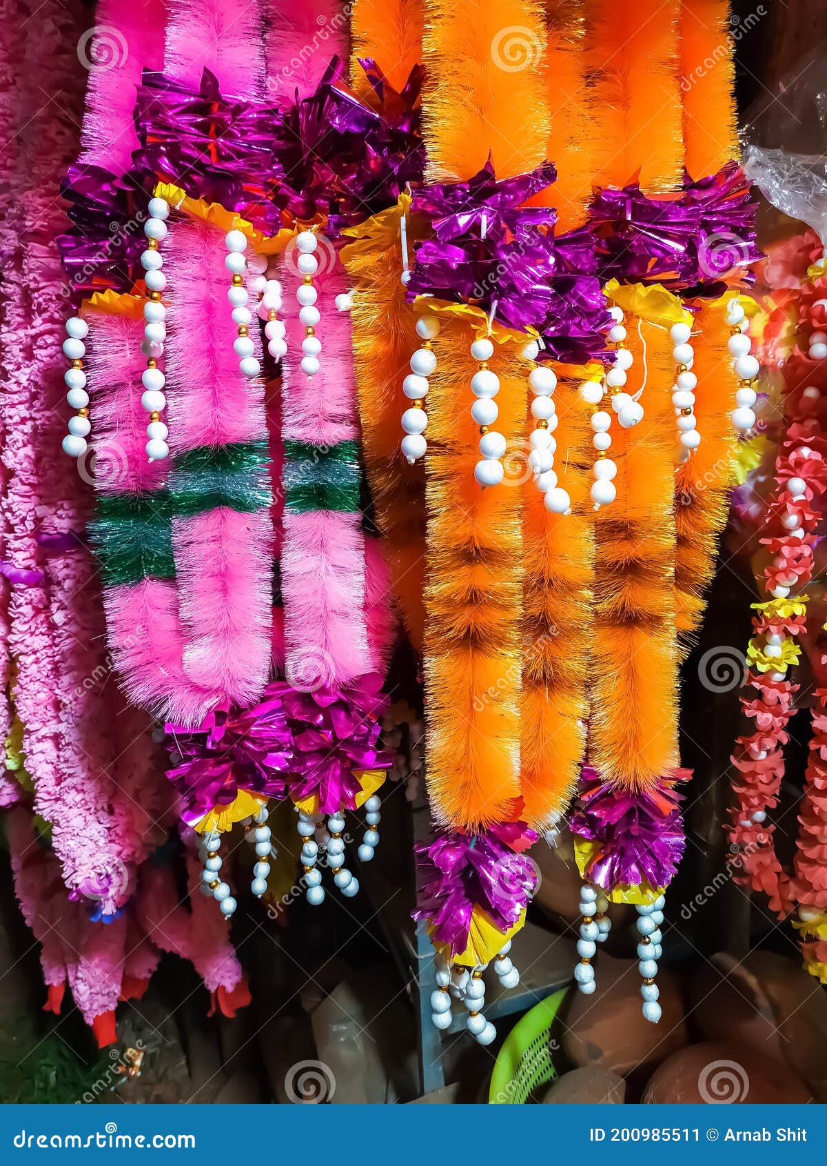 Multiple Colours of Plastic Flower Garlands. Used in Durga Puja and