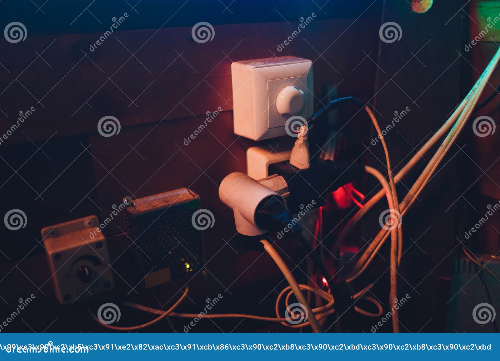Multiple Electrical Plugs in Wall Outlet Mixed Up. Stock Photo Image