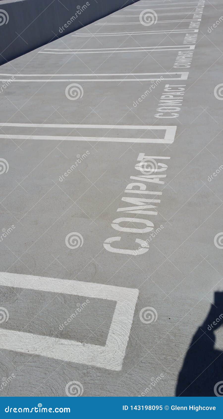 Multiple Empty Compact Parking Spaces on Concrete or Asphalt Parking