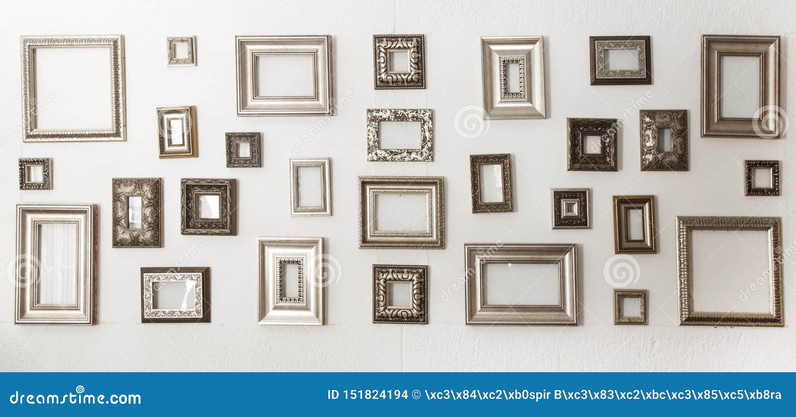 Multiple Many Blank Small Picture Frames on White Wall Stock Photo