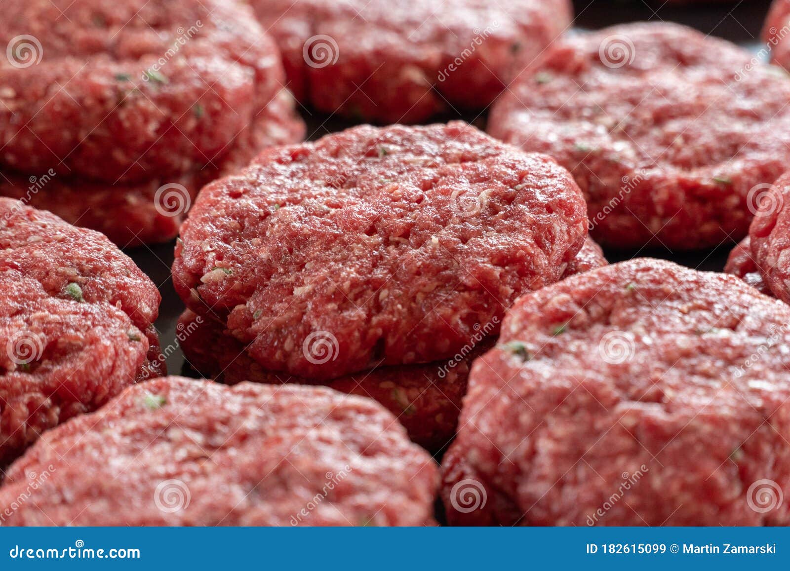 Multiple Stacks of Freshly Processed Raw Hamburger Patties on Display
