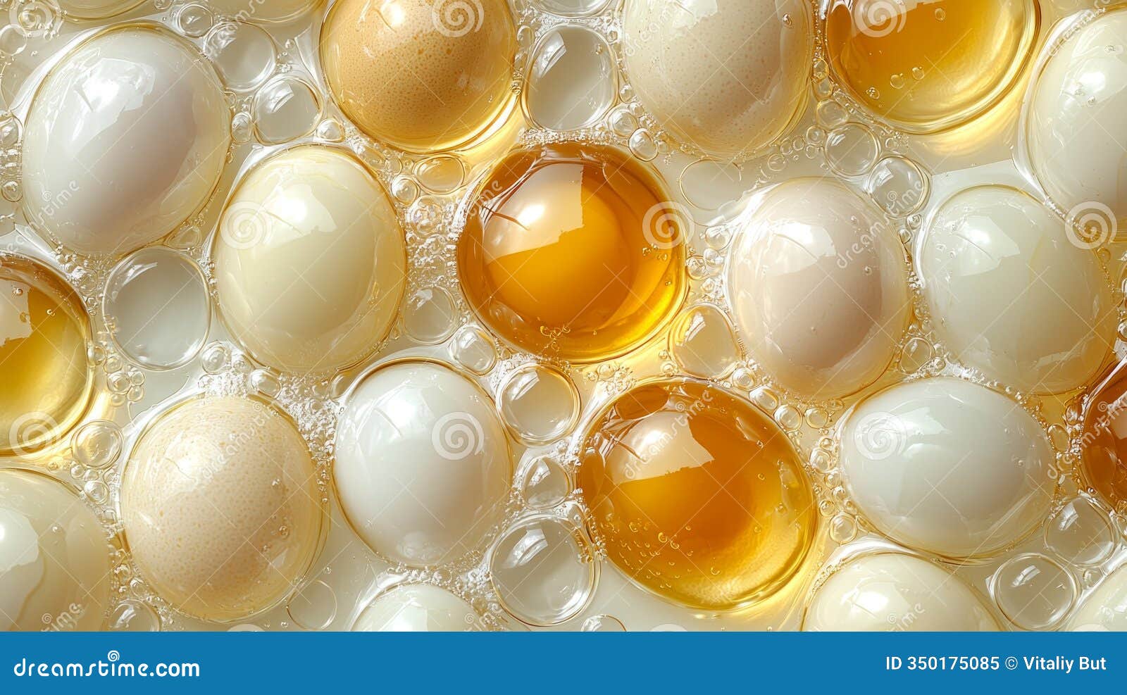 multiple vibrant egg yolks float in clear oil inside glass container showcasing their  and color against clean