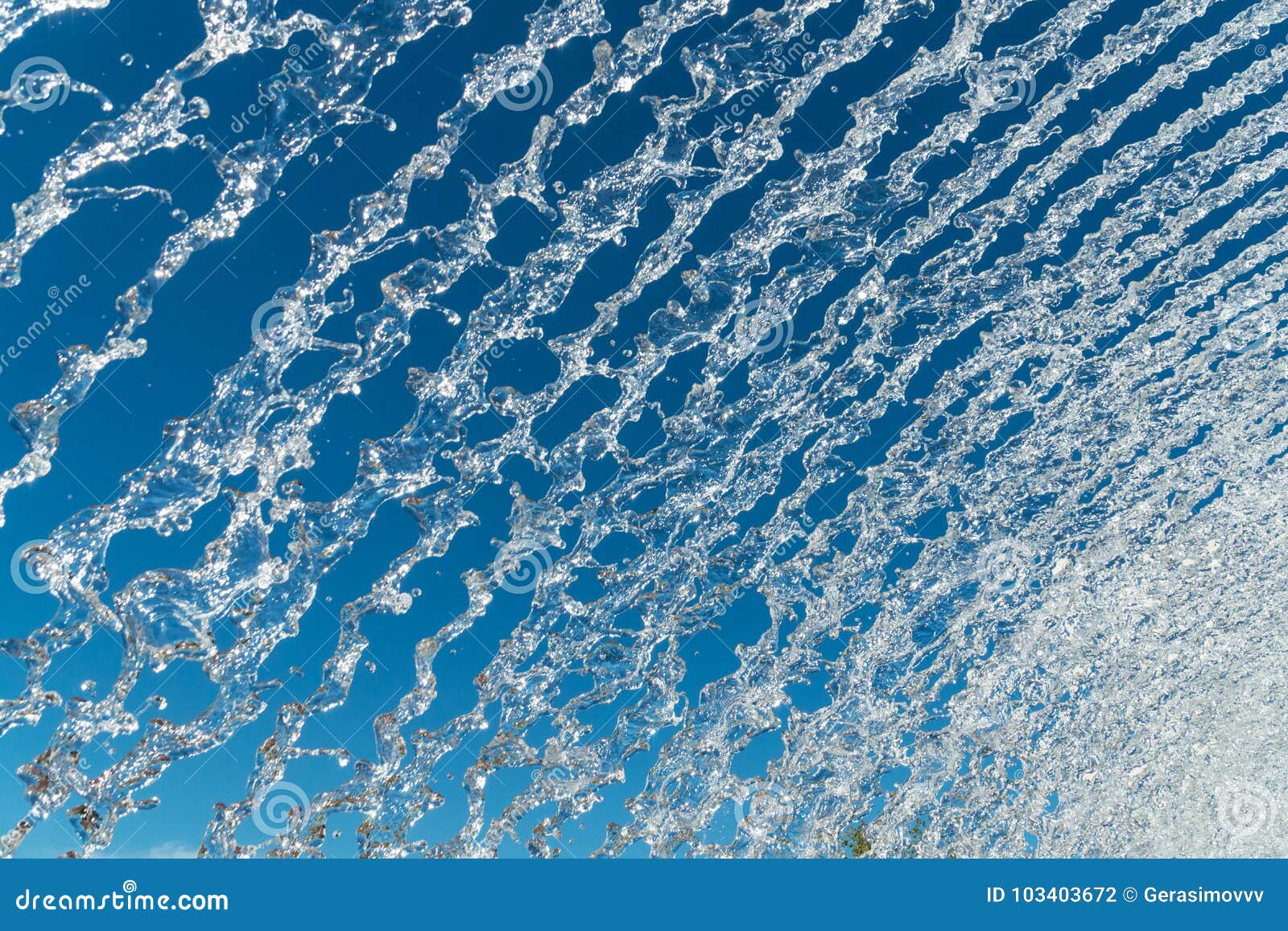 Water jets over a blue sky stock photo. Image of park 103403672