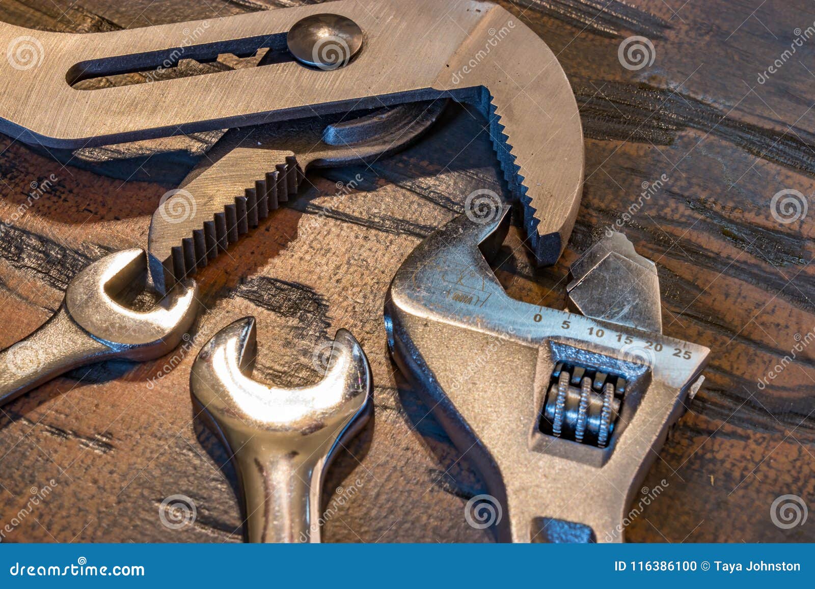 Multiple wrenches on wood stock photo. Image of industry 116386100