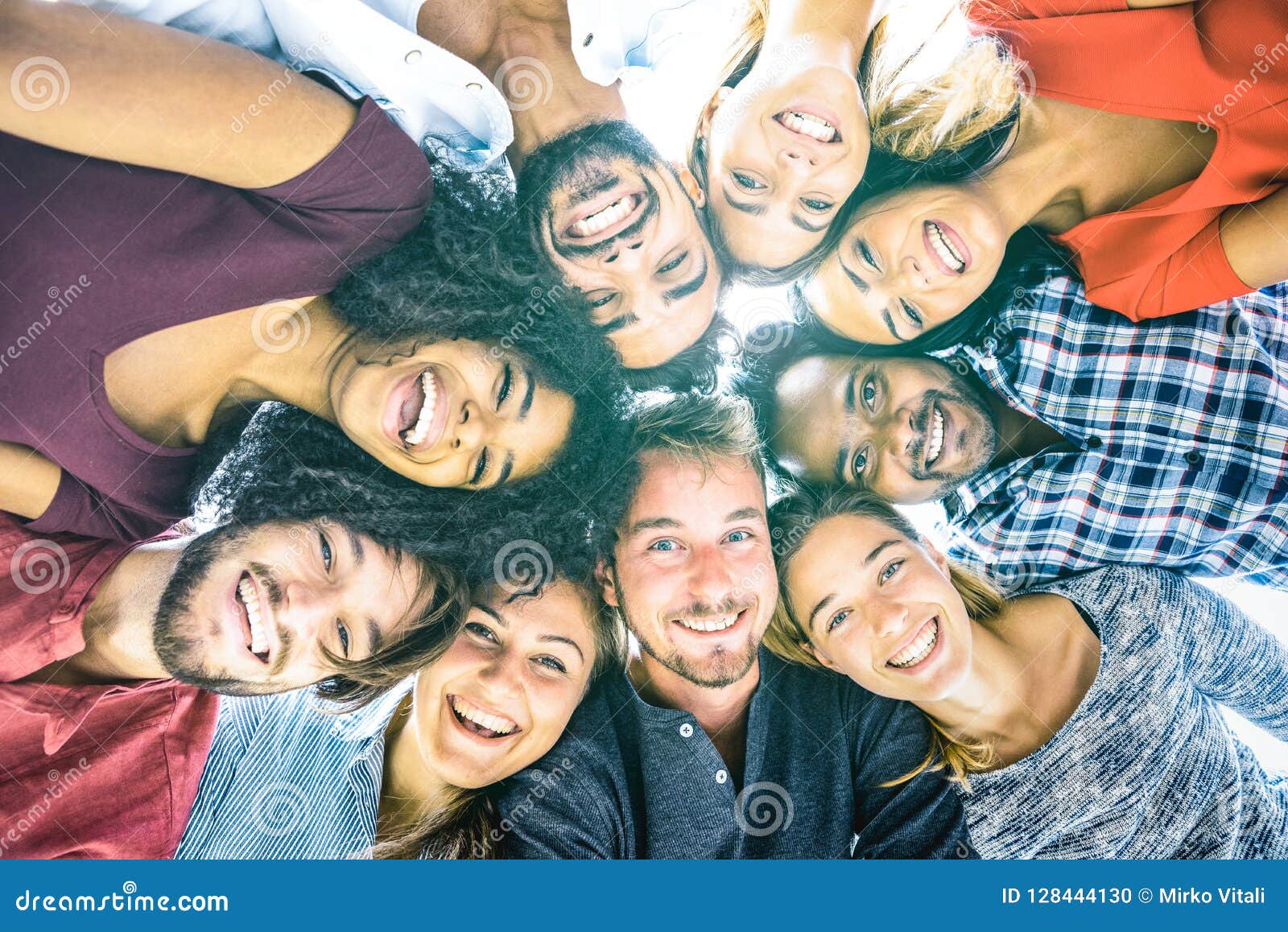 multiracial best friends millennials taking selfie outdoors