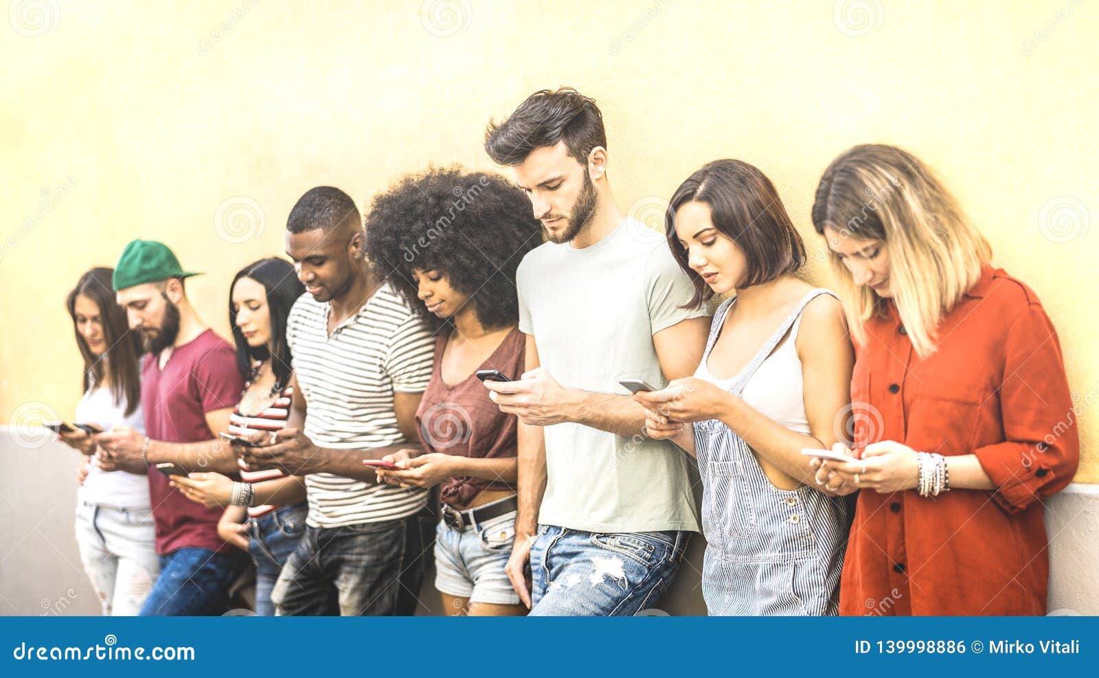 multiracial friends using mobile smartphone at university coampus - millenial people addicted by smart phones - tech concept