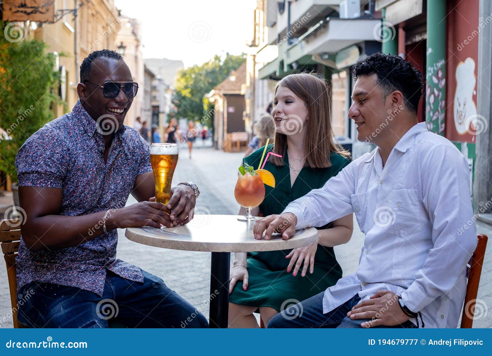 Multiracial Group Of Friends Drinking At Street Cafe Stock Image