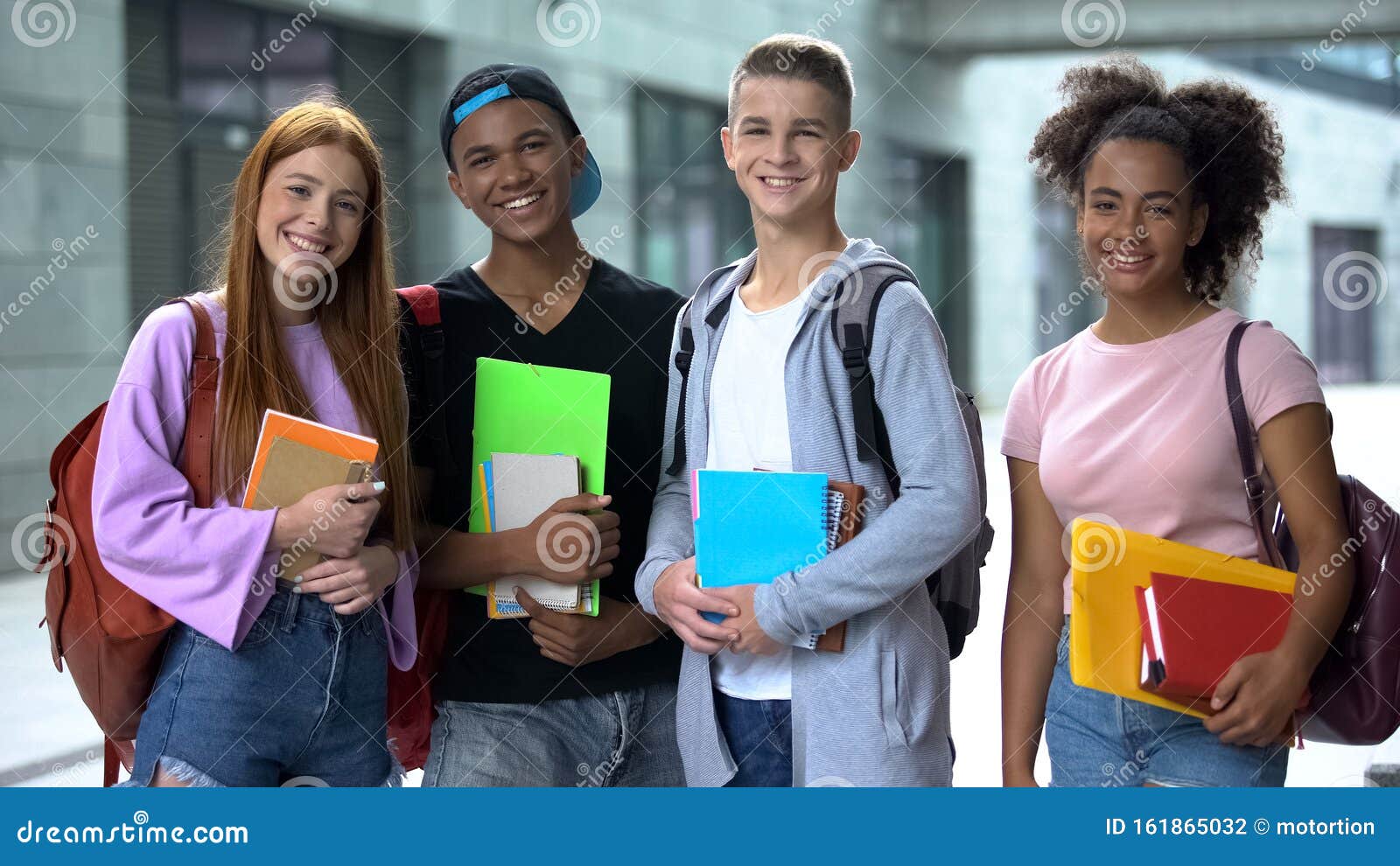 multiracial high school students with books smiling camera, educational program