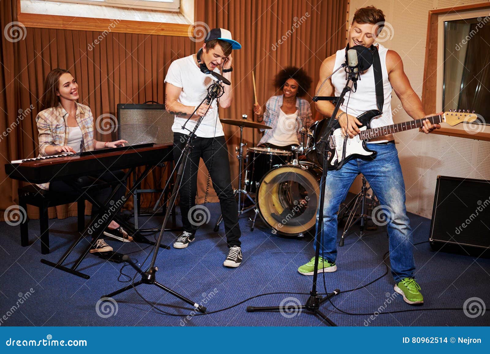 Multiracial Music Band Performing in a Recording Studio Stock Photo Image of concert, band
