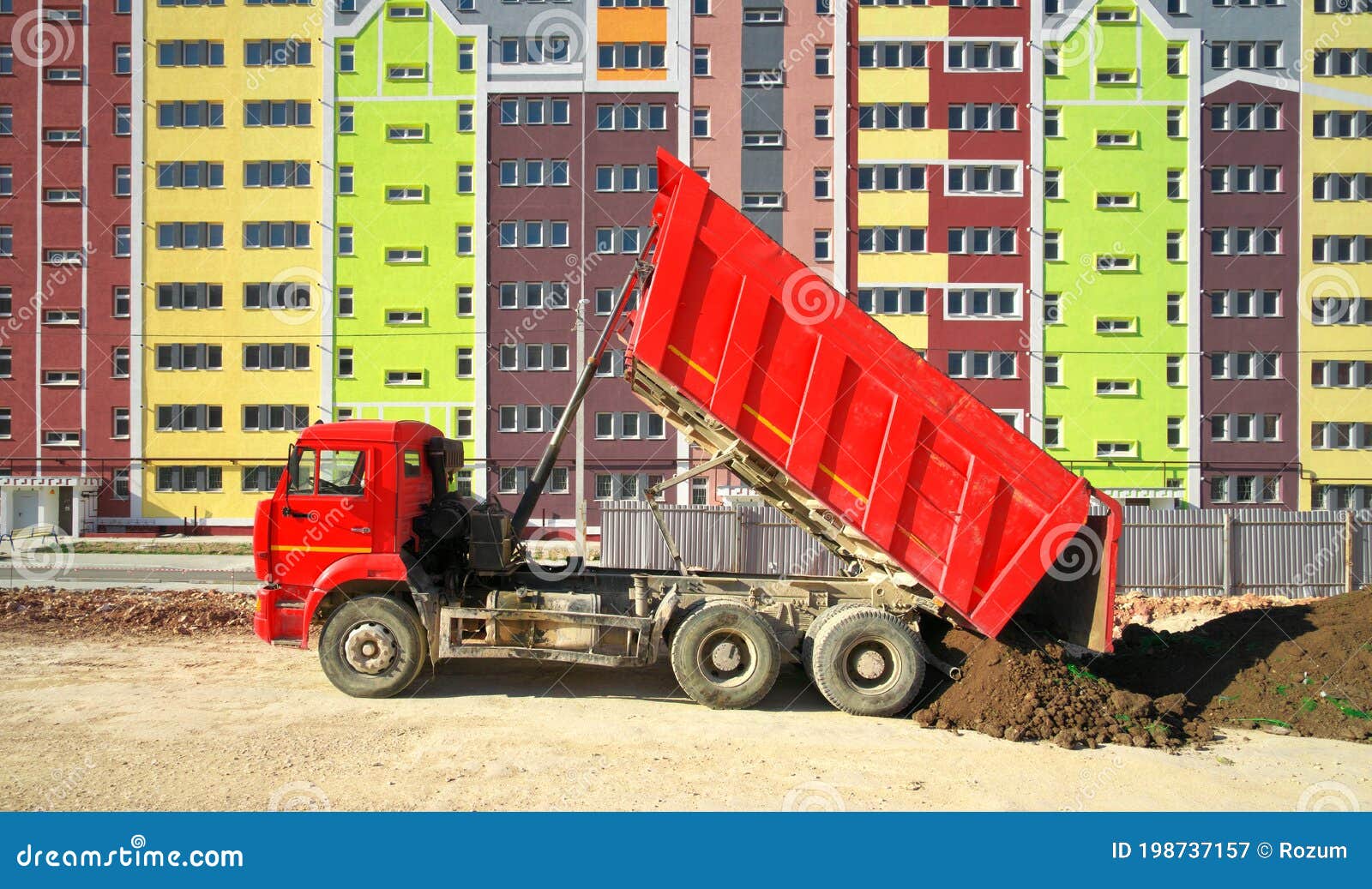 multistorey building apartment house and dump truck unload soil