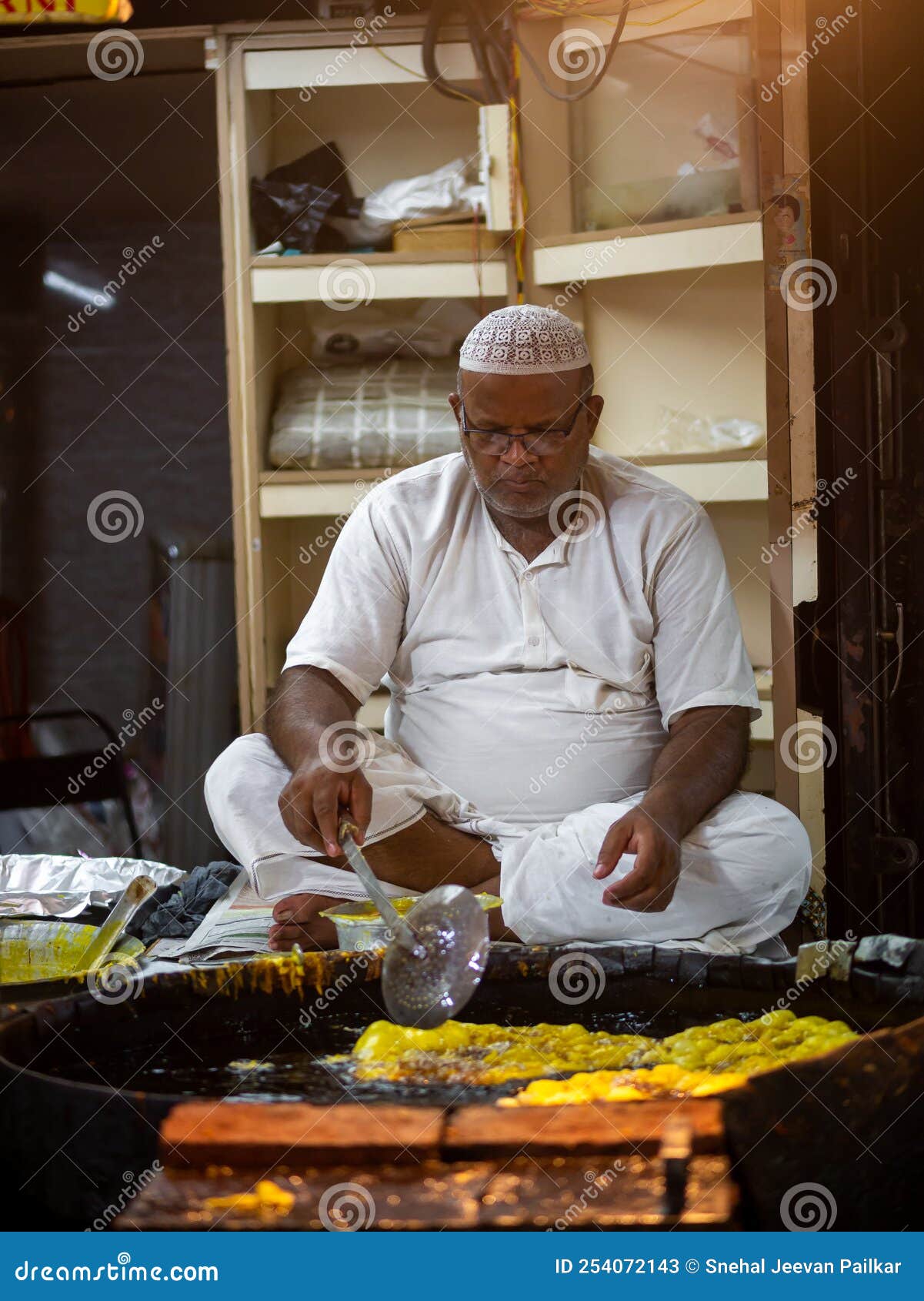 Muslim Male Vendor Cooking Selling Halal Foods And Snacks Fried Pancake muslim-male-vendor-cooking-selling-halal-foods-and-snacks-fried-pancake