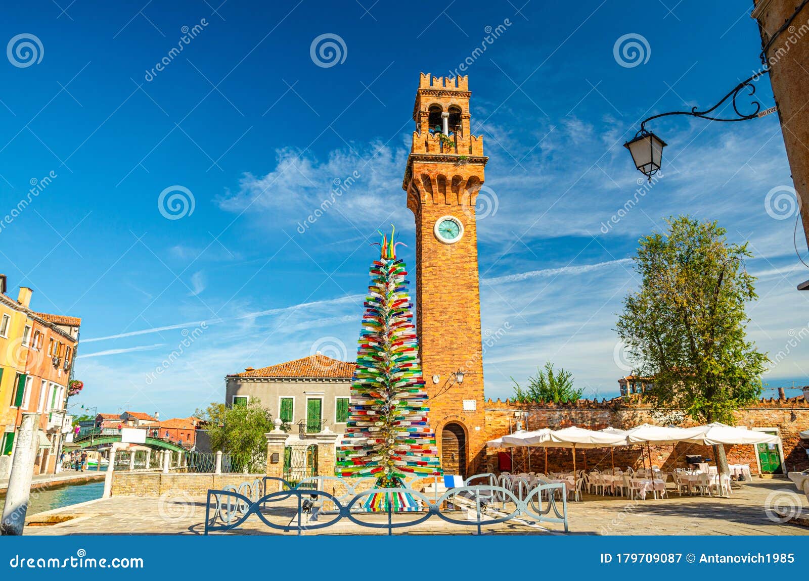 murano clock tower torre dell`orologio of san stefano church, colorful christmas tree made of murano glass