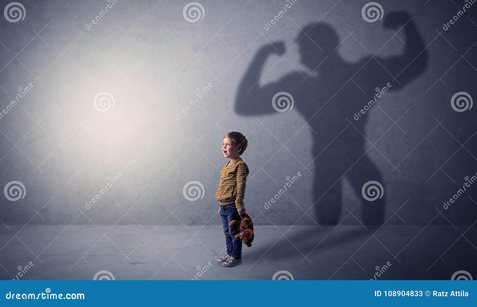 muscleman shadow behind waggish little boy