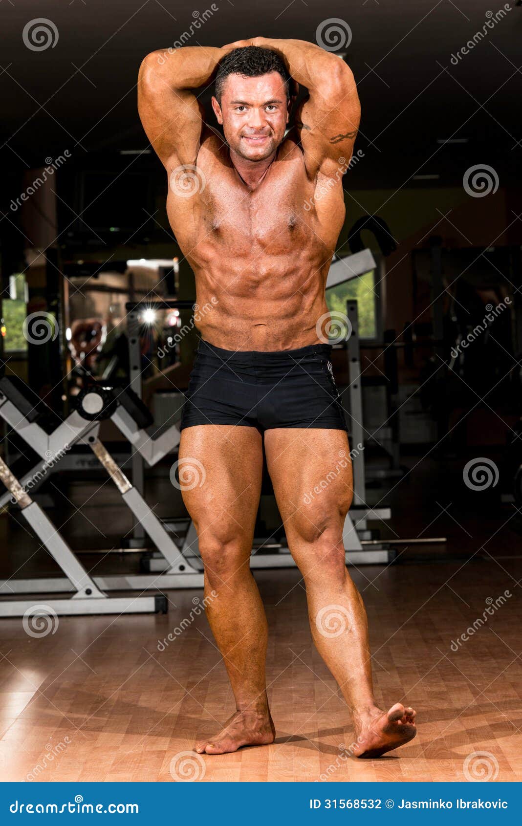 Muscular Bodybuilder Showing His Front Abdominal Abs Stock Photo