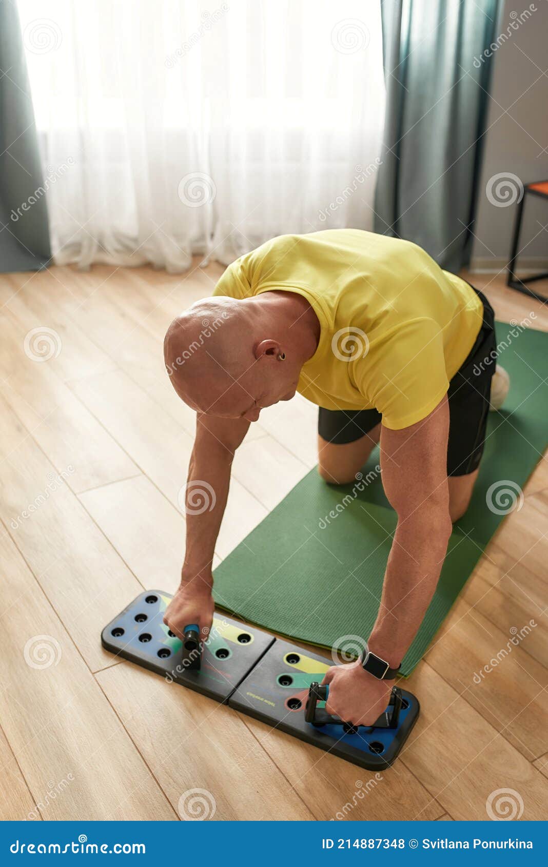 muscular caucasian man exercising on push up training system