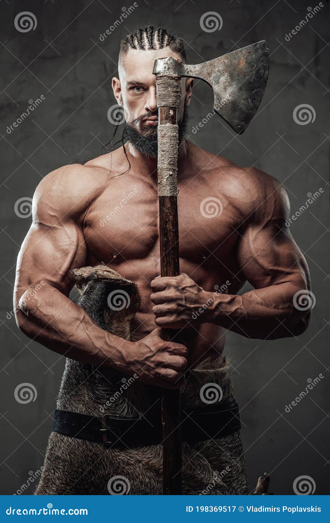 muscular guy dressed like viking posing in dark background