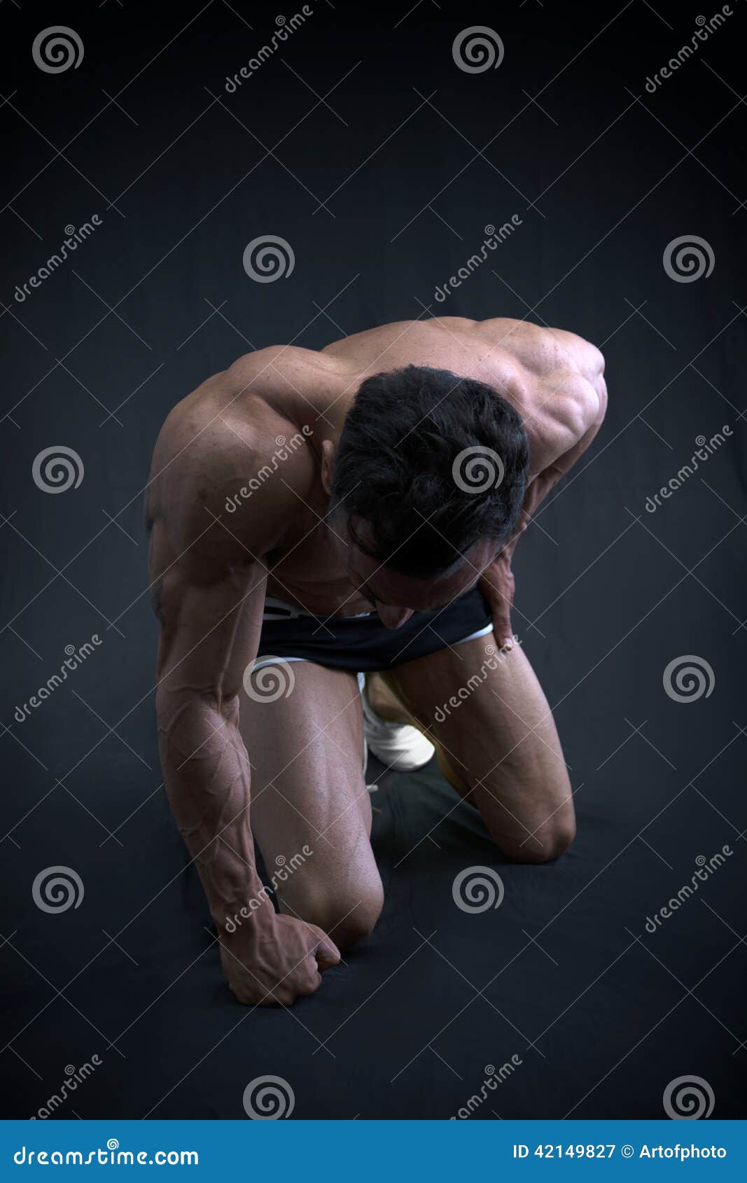 Muscular Male Bodybuilder Kneeling with Head Down Stock Image Image