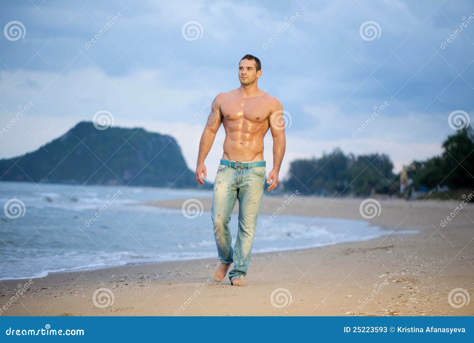 A bulky, muscular guy on the beach