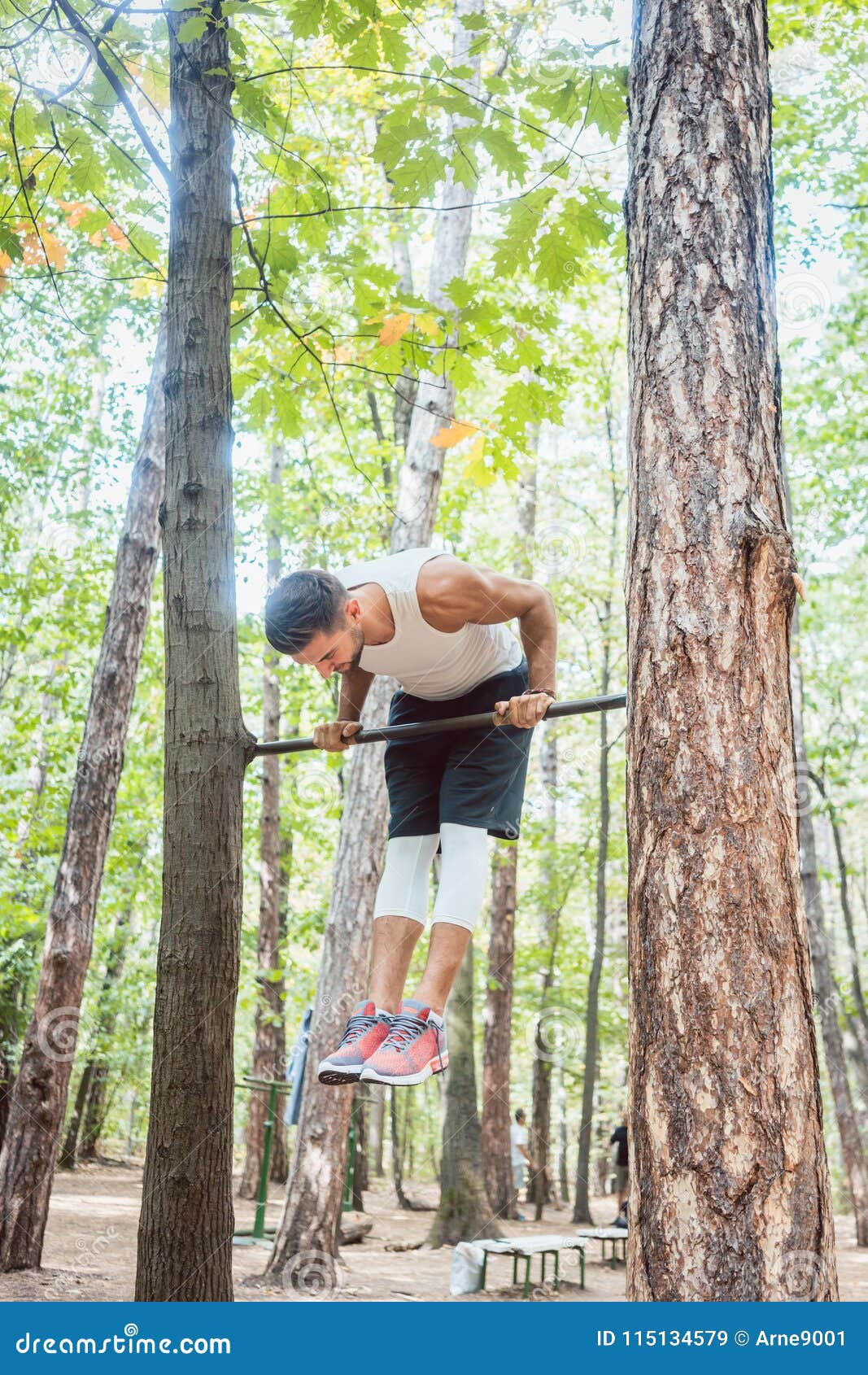 Man Doing Gymnastics on High Bar in the Woods Stock Image Image of