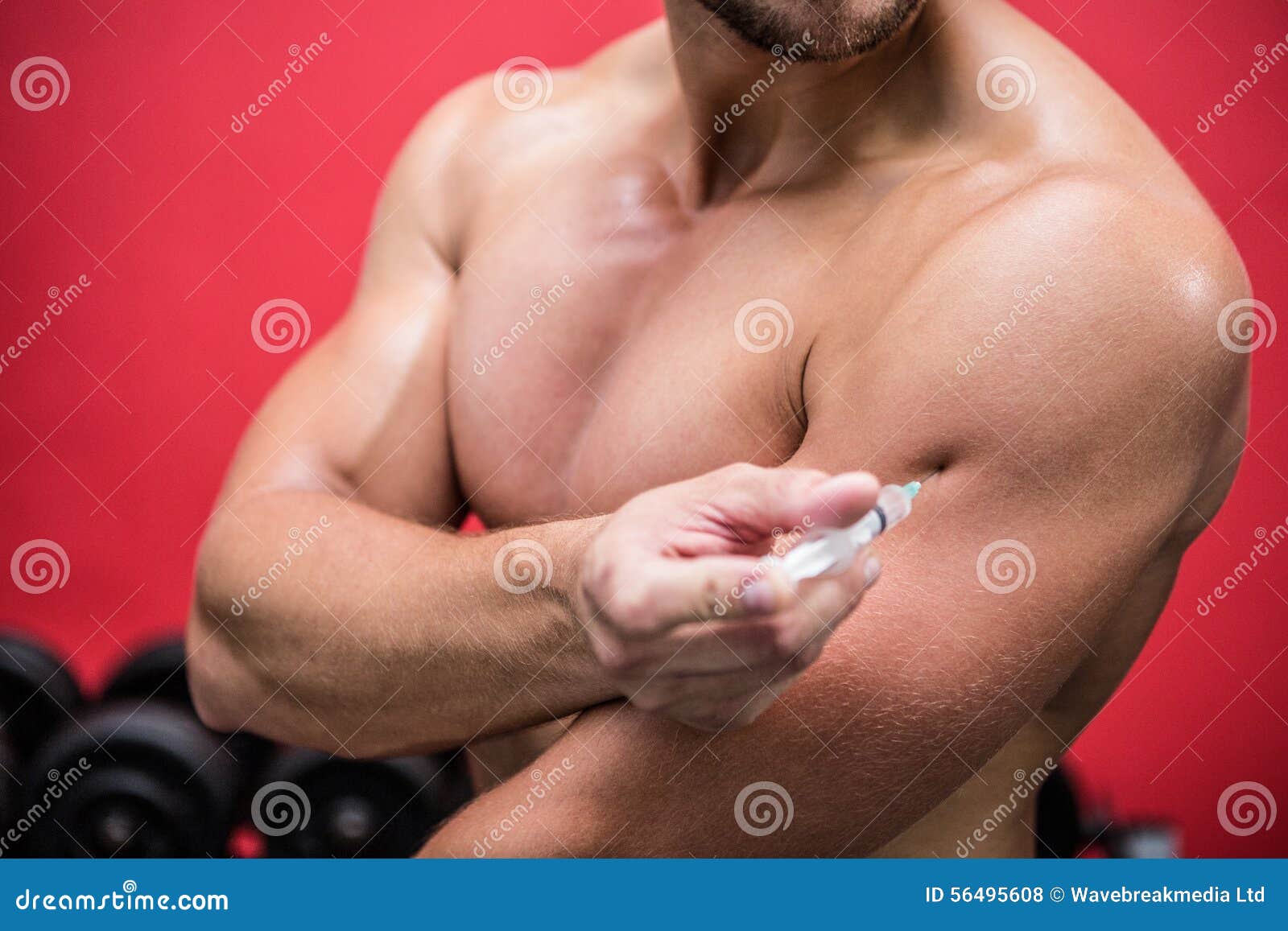 muscular man injecting steroids