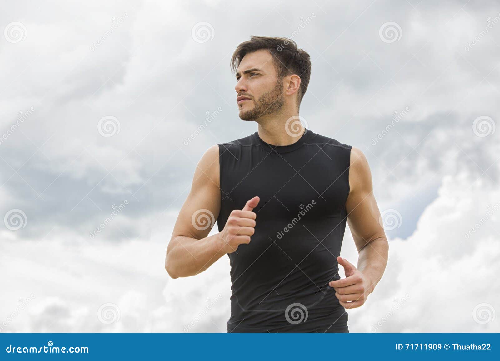 Muscular Man Jogging Outdoors, Dramatic Sky Backdrop Stock Image ...