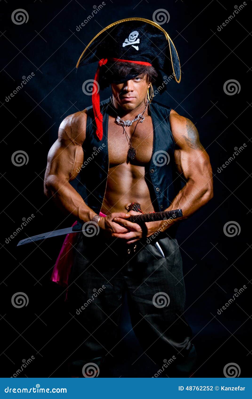 Muscular Man In A Pirate Costume With A Sword On A Black Background