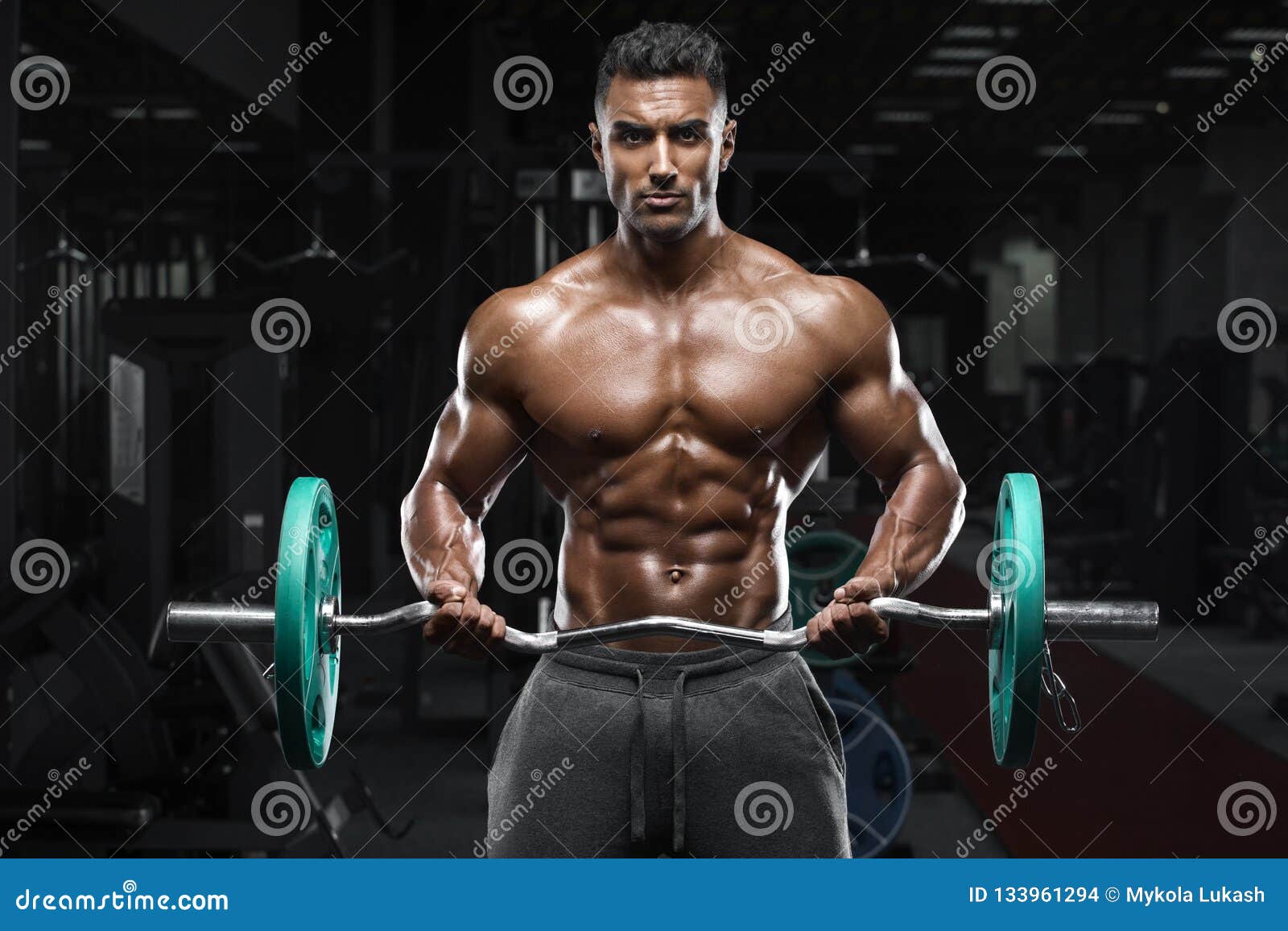 Muscular Man Working Out In Gym Doing Exercises Stock 