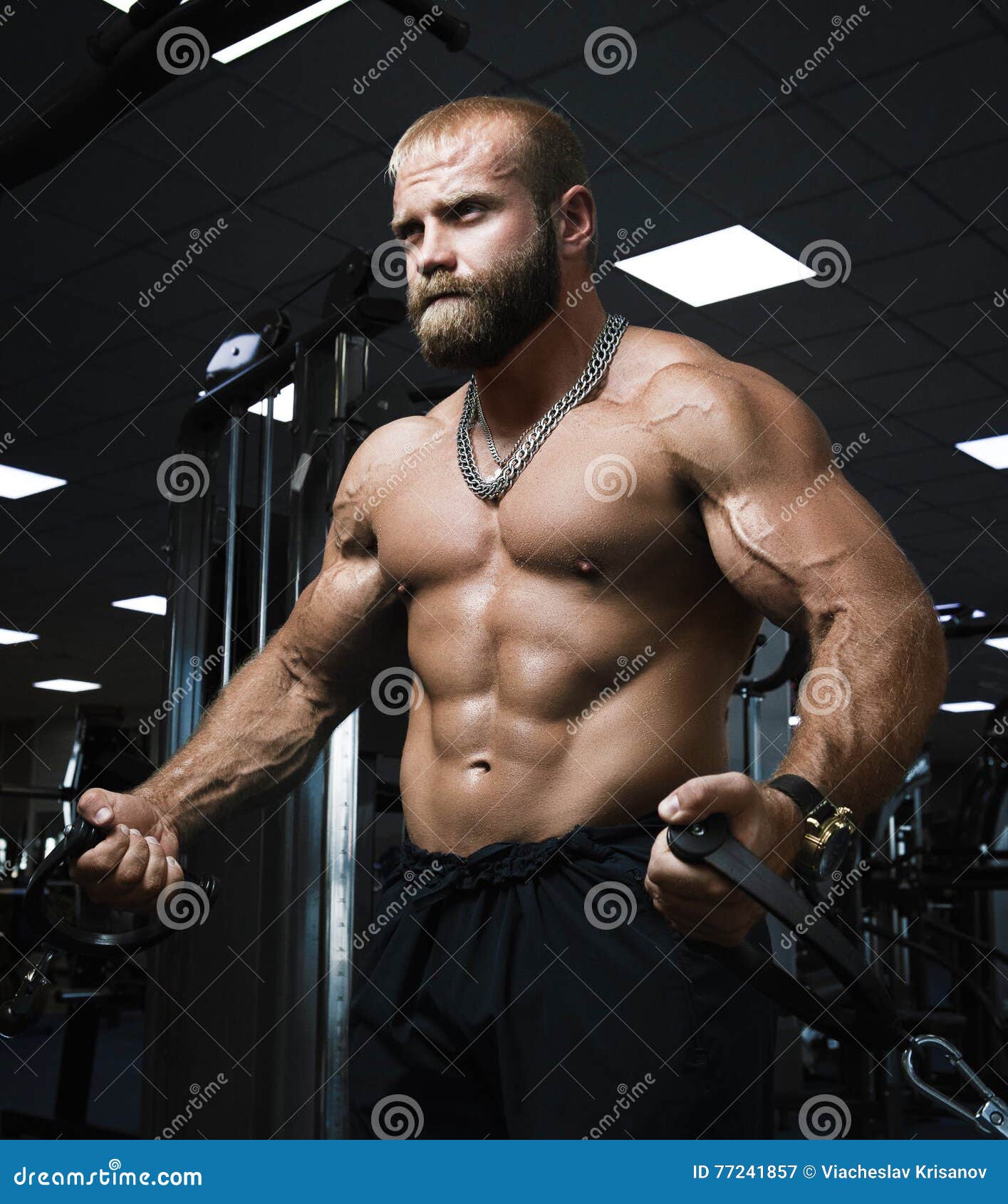 Muscular Man Working Out In Gym Doing Exercises With 