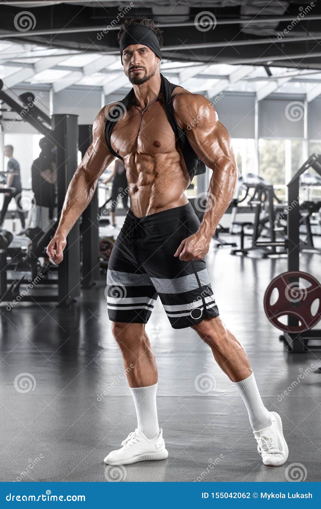 Muscular Man With Dumbbells In Gym. Strong Male Naked 