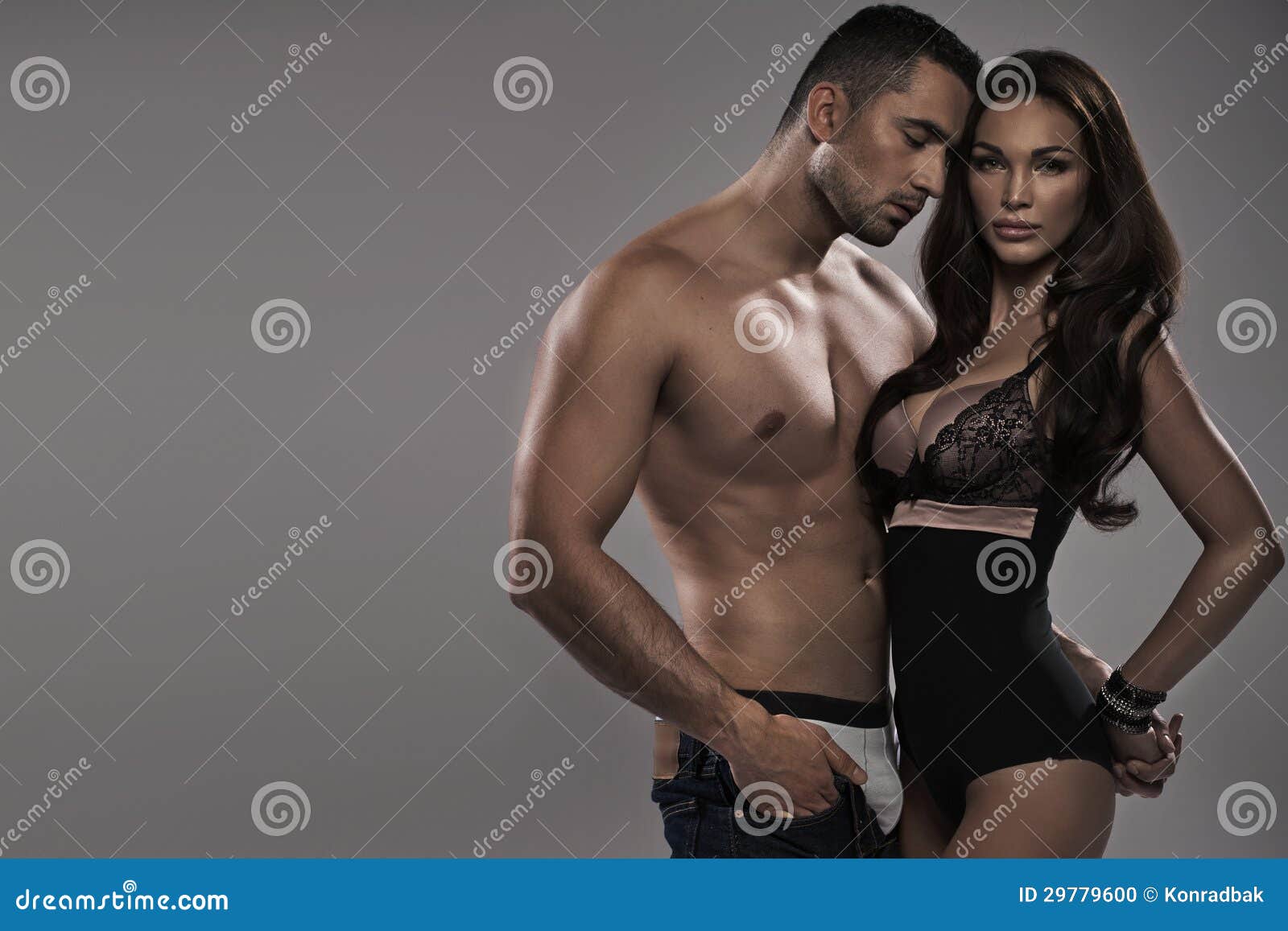 Muscular Man Touching His Alluring Wife Stock Photo photo