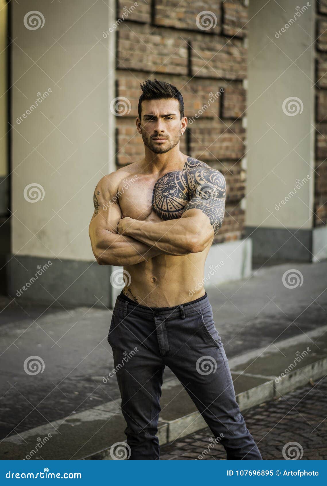 muscular shirtless man in city centre