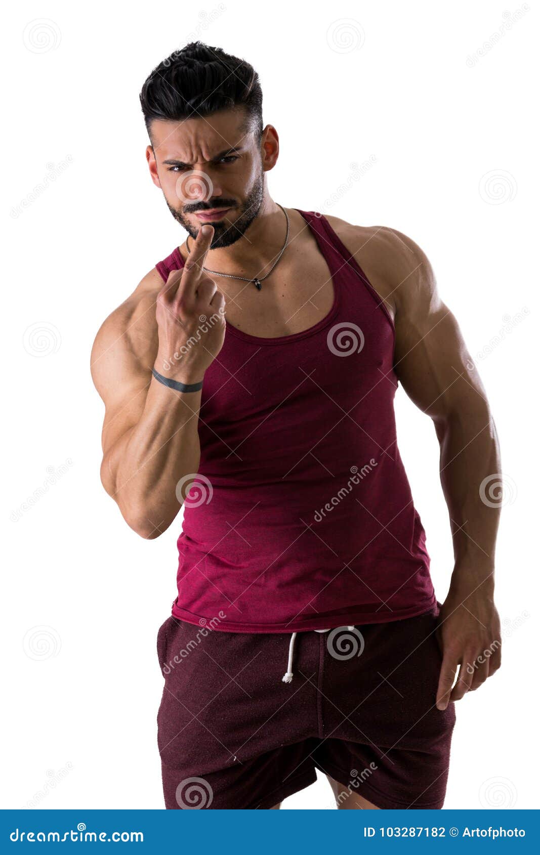 Muscular, shirtless man doing `screw you` sign with middle finger looking at camera