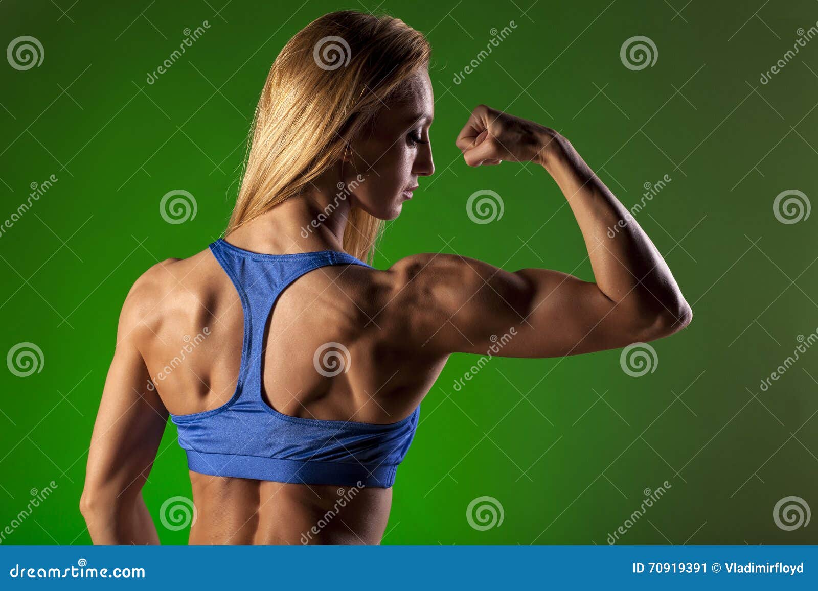 Woman flexing her muscles and showing her toned back Royalty-Free