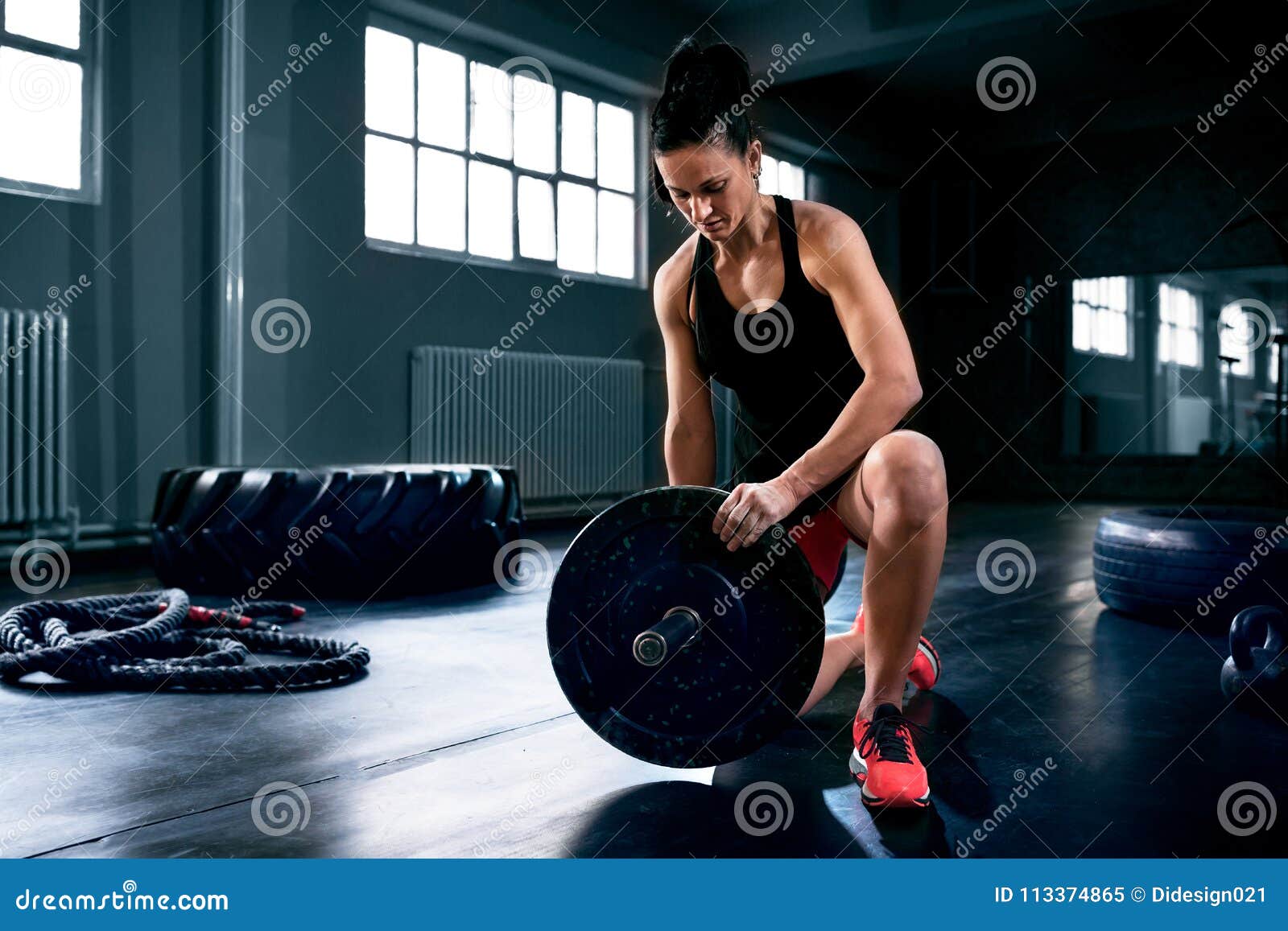 Muscular Young Woman Putting Heavy Weights for Exercise Stock Image ...