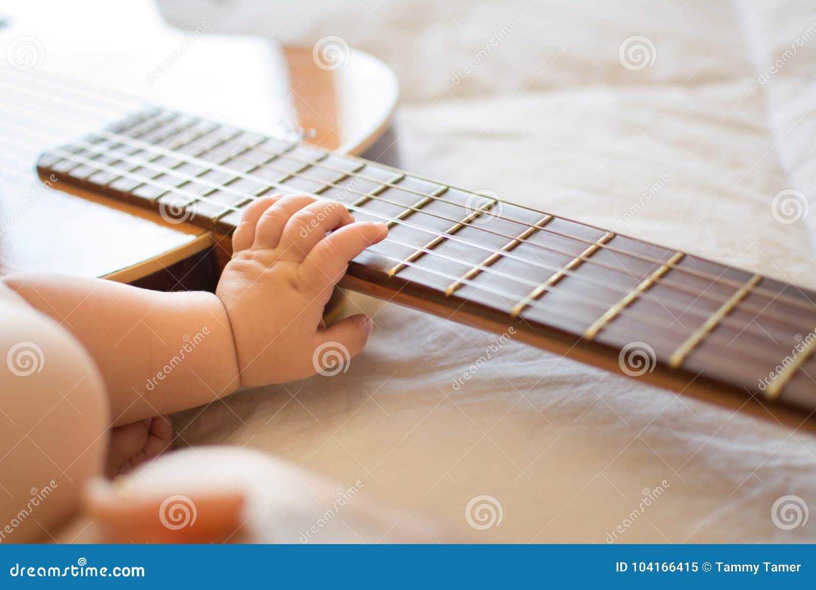 baby arm on guitar